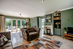 Draawing room styled in sage green in a contemporary house for sale in Churton