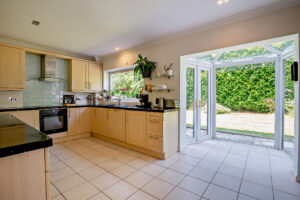 contemporary kitchen with french doors to the garden in a house for sale in Churton