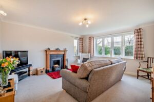 the sitting room with open fire in a house for sale in Farndon marketed by Rickitt Partnership estate agents